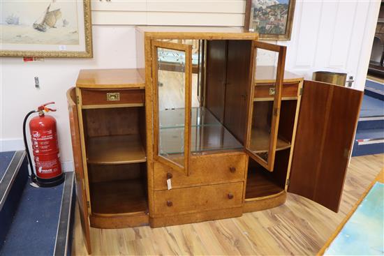 An Art Deco birds eye maple display cabinet and similar dining table,